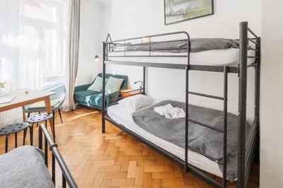 a room with two bunk beds and a table at Bright downtown studio in Prague