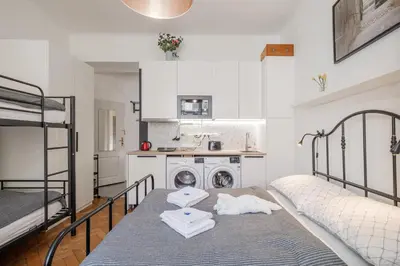 a room with two bunk beds and a kitchen at Bright downtown studio in Prague
