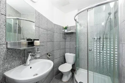 a bathroom with a sink and a toilet and a shower at Bright downtown studio in Prague