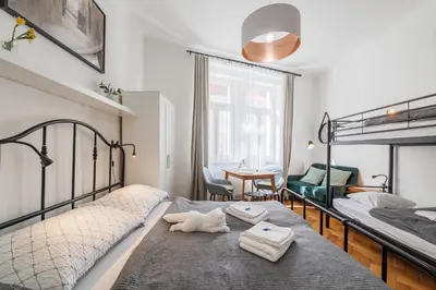 a bedroom with two bunk beds and a table at Bright downtown studio in Prague