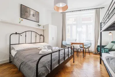 a bedroom with a bed and a table and chairs at Bright downtown studio in Prague