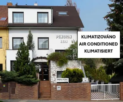 a white building with a sign in front of it at Pension Kern in Prague