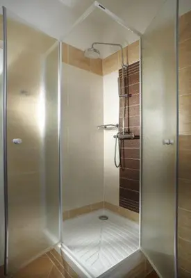 a shower with a glass door in a bathroom at Pension Kern in Prague