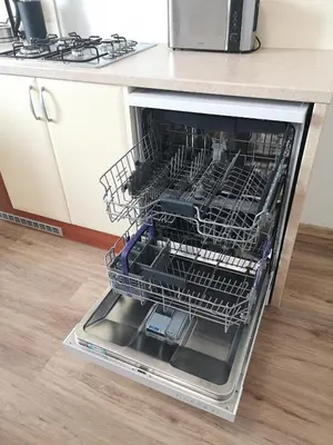 a dishwasher with dishes inside of it in a kitchen at Fine apartment in centrum of Slaný with Aircondition in Slaný