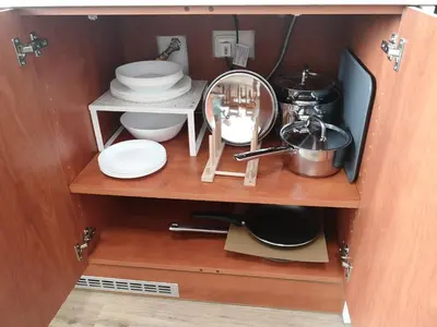 a cupboard with dishes and a mirror in it at Fine apartment in centrum of Slaný with Aircondition in Slaný