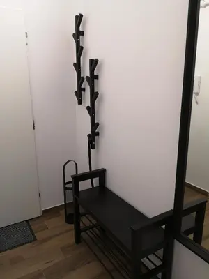 a black chair in a room with a mirror at Fine apartment in centrum of Slaný with Aircondition in Slaný