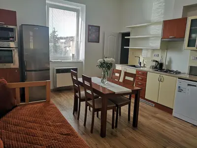 a kitchen with a table and chairs and a refrigerator at Fine apartment in centrum of Slaný with Aircondition in Slaný
