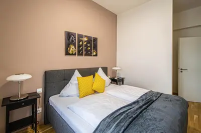 a bedroom with a bed with yellow and white pillows at Stylish apartment in Prague best gastronomic area in Prague