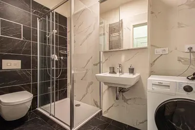 a bathroom with a toilet and a sink and a shower at Stylish apartment in Prague best gastronomic area in Prague