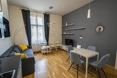 a living room with a blue couch and a table at Stylish apartment in Prague best gastronomic area in Prague