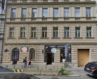 a large stone building with people walking in front of it at Stylish apartment in Prague best gastronomic area in Prague