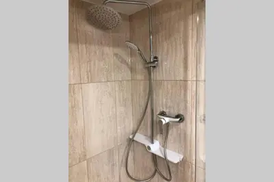 a shower with a shower head in a bathroom at Chatka - C - Vyhlídka nad řekou in Zdiby
