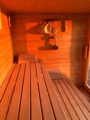 a sauna with two wooden benches in a room at Chatka - C - Vyhlídka nad řekou in Zdiby