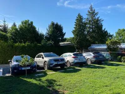 a group of parked cars parked in a yard at Chatka - C - Vyhlídka nad řekou in Zdiby