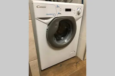 a white washer and dryer in a room at Chatka - C - Vyhlídka nad řekou in Zdiby