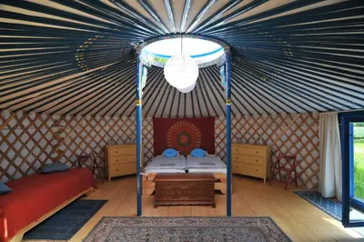 a room with a bed in a yurt at Jurty v Sadu in Český Brod