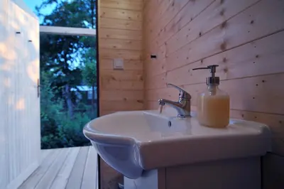 a bathroom with a sink with a soap dispenser on it at Jurty v Sadu in Český Brod