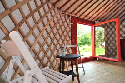a room with a window and a chair and a table at Jurty v Sadu in Český Brod