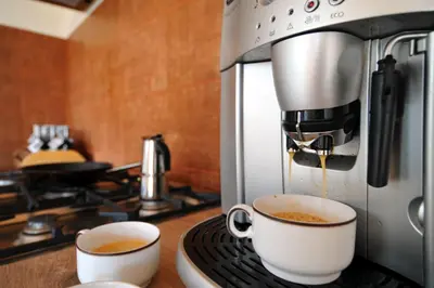 two cups of coffee are being brewed in a microwave at Jurty v Sadu in Český Brod