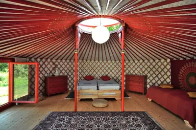 a room with a bed in a yurt at Jurty v Sadu in Český Brod