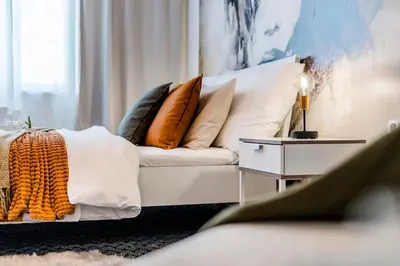 a living room with a white couch with pillows at Romantic Apts Prague by Michal&Friends in Prague