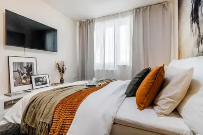 a bedroom with a bed with a television on the wall at Romantic Apts Prague by Michal&Friends in Prague