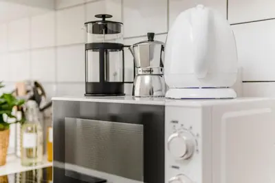 a blender on top of a microwave in a kitchen at Romantic Apts Prague by Michal&Friends in Prague
