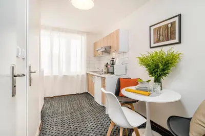 a small kitchen with a white table and chairs at Romantic Apts Prague by Michal&Friends in Prague