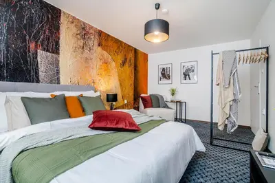 a bedroom with a large white bed with colorful pillows at Romantic Apts Prague by Michal&Friends in Prague