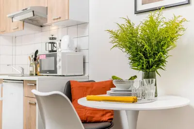 a white table with a vase on it in a kitchen at Romantic Apts Prague by Michal&Friends in Prague