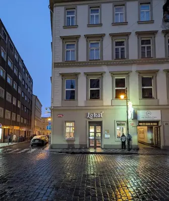 a building on a street in a city at night at Lokal apartment in Prague