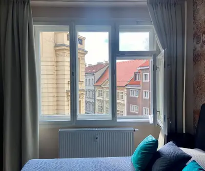 a bedroom window with a view of a building at Lokal apartment in Prague