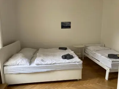 two beds in a room with white sheets at Castle View Apartment in Prague