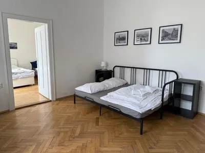 a bedroom with a bed and a mirror on the wall at Castle View Apartment in Prague