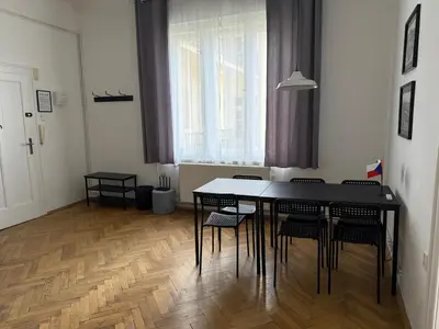 a dining room with a black table and chairs at Castle View Apartment in Prague