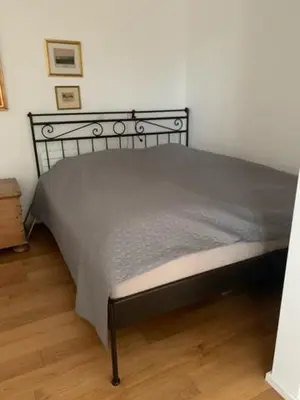 a bed with a metal frame in a bedroom at byt Panorama Hlubočepy in Prague