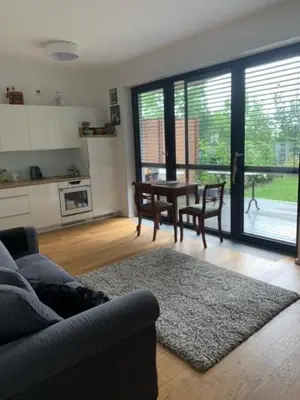 a living room with a couch and a table at byt Panorama Hlubočepy in Prague