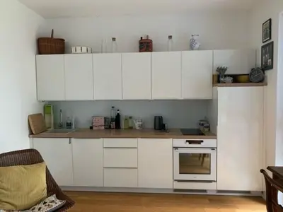 a kitchen with white cabinets and a stove at byt Panorama Hlubočepy in Prague
