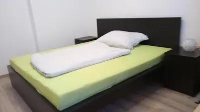 a bedroom with a bed with a green and yellow mattress at Apartman Xaveriova in Prague