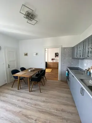 a kitchen and dining room with a table and chairs at Apartman Xaveriova in Prague