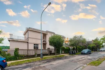 a house on a street with a street light at Apartman Xaveriova in Prague