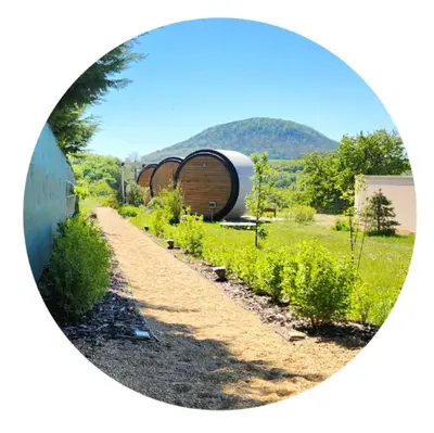 a circular picture of a garden with a barrel at RIP by Říp in Krabčice