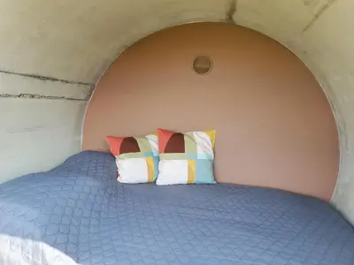 a bed with two colorful pillows in a room at RIP by Říp in Krabčice
