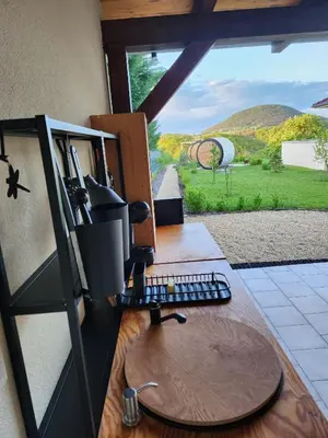 a computer sitting on a desk with a view of a field at RIP by Říp in Krabčice