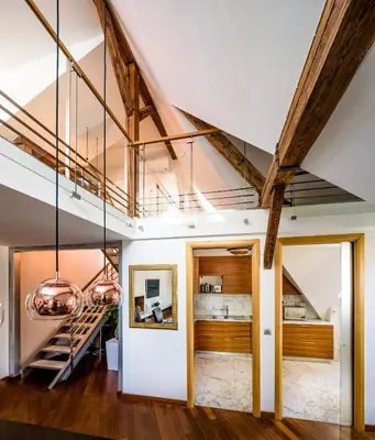 a living room with a staircase and vaulted ceilings at Triplex Kings Apartment in Old Town in Prague