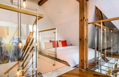 a bedroom with a bed and a glass staircase at Triplex Kings Apartment in Old Town in Prague