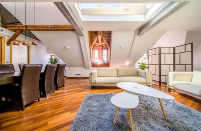 a living room with a table and chairs at Triplex Kings Apartment in Old Town in Prague