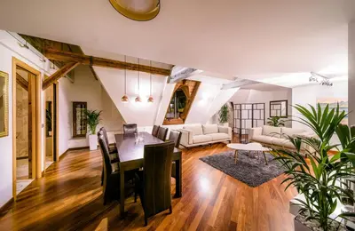 a dining room and living room with a table and chairs at Triplex Kings Apartment in Old Town in Prague