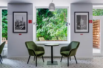 a waiting room with two chairs and a table and a window at Revelton Studios Prague in Prague