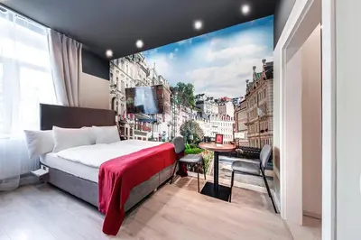 a room with a bed and a view of a city at Revelton Studios Prague in Prague